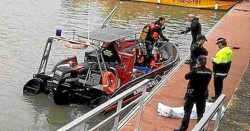 Imagen del rescate del cuerpo sin vida en el Guadalquivir. Imagen del rescate del cuerpo sin vida en el Guadalquivir.