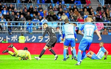 Feddal frena con el cuerpo a los delanteros del Málaga mientras que Adán atrapa la pelota. Feddal frena con el cuerpo a los delanteros del Málaga mientras que Adán atrapa la pelota.